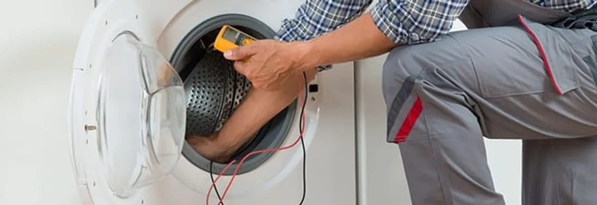 Dryer repair technician inspecting and repairing a clothes dryer in Buffalo, NY